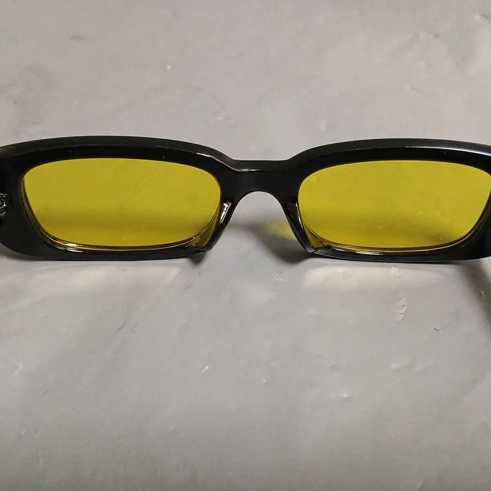 BOXED PAIR OF EYEKONIK BLACK FRAMED GLASSES WITH YELLOW TINT LENS