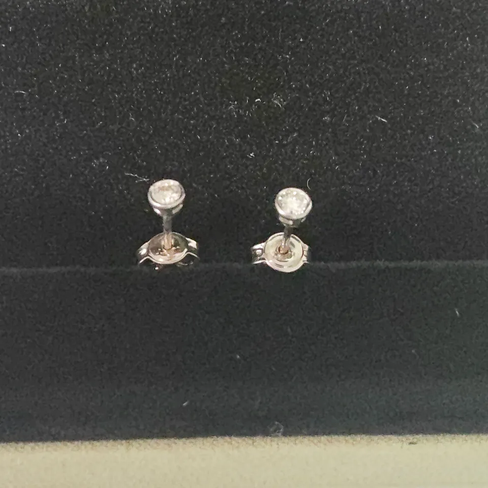 18CT WHITE GOLD RUB-OVER STUDS SET WITH NATURAL DIAMONDS