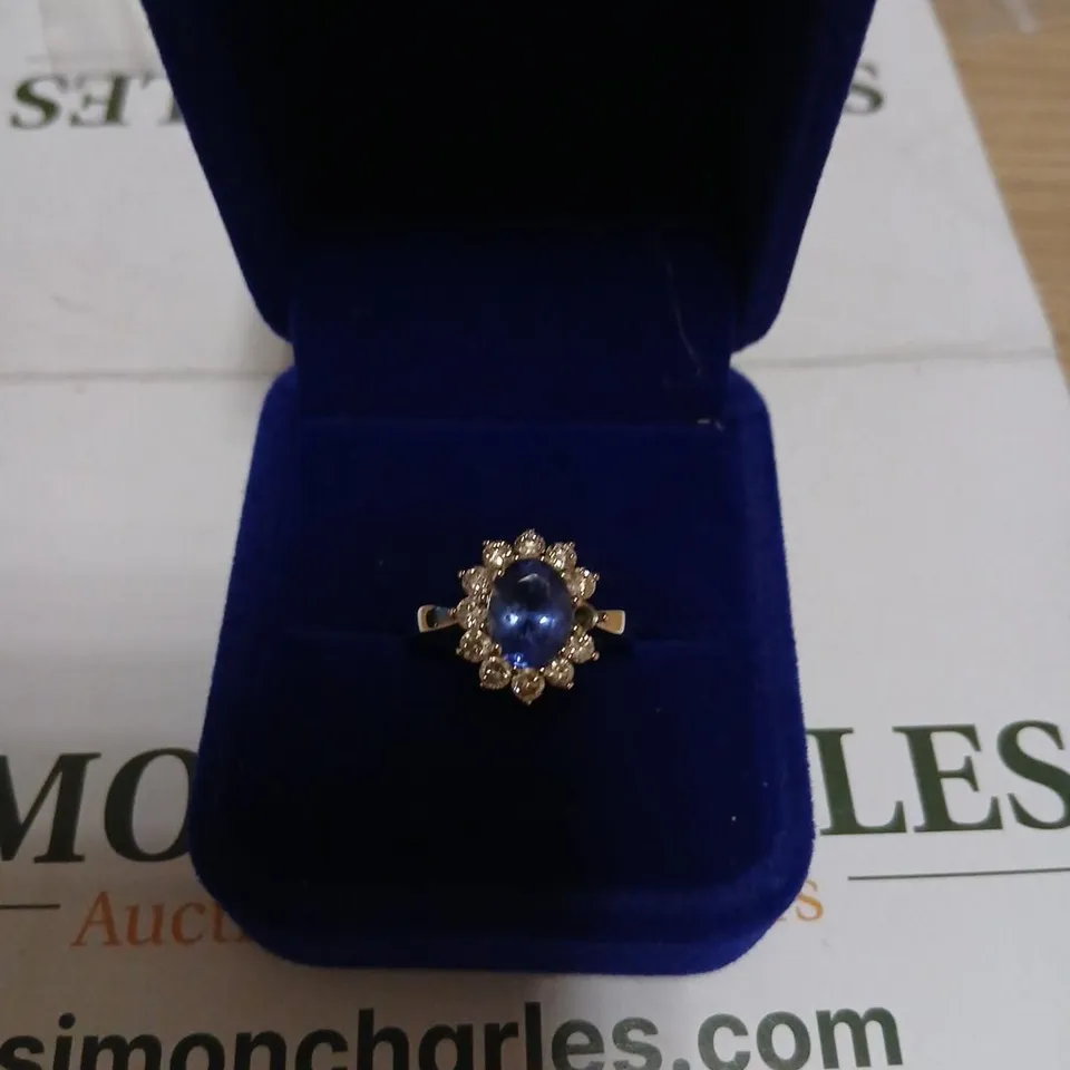 DIAMONIQUE YELLOW GOLD RING WITH OVAL BLUE SAPPHIRE STYLE STONE AND HALO