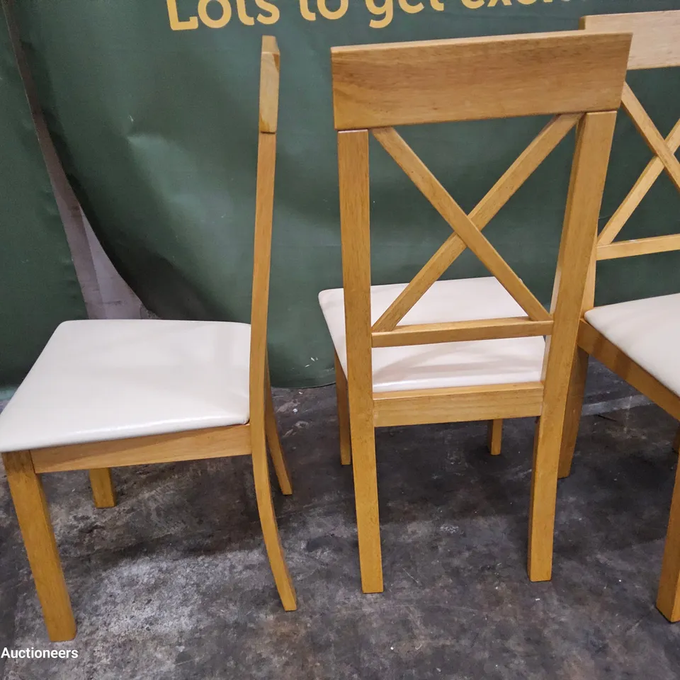 SET OF FOUR NATURAL WOOD X BACK DINING CHAIRS CREAM PU SEAT PADS