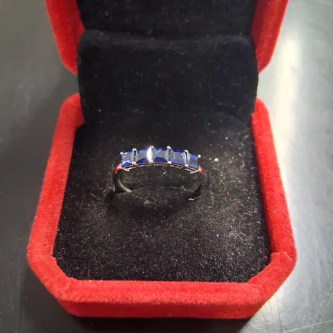 18CT WHITE GOLD HALF ETERNITY RING SET WITH PRINCESS CUT SAPPHIRES WEIGHING +1.10CT