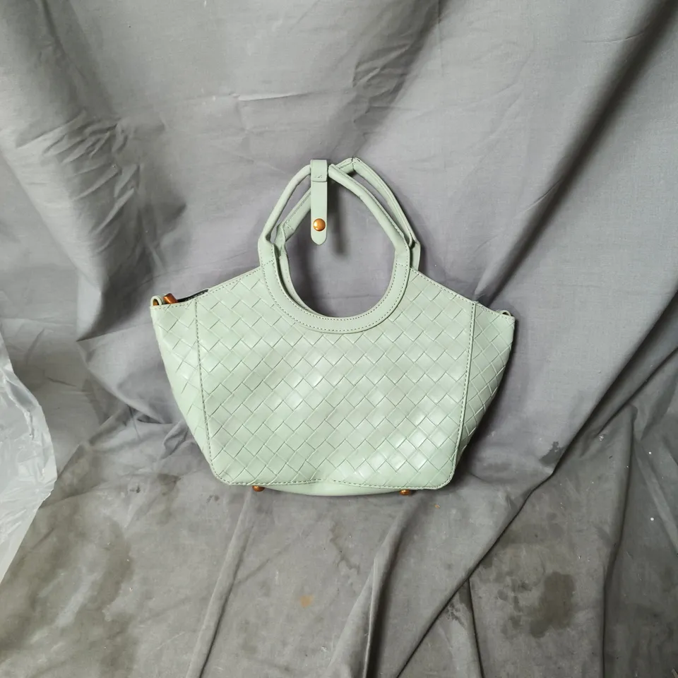 Mint green woven leather handbag with circular top handles 