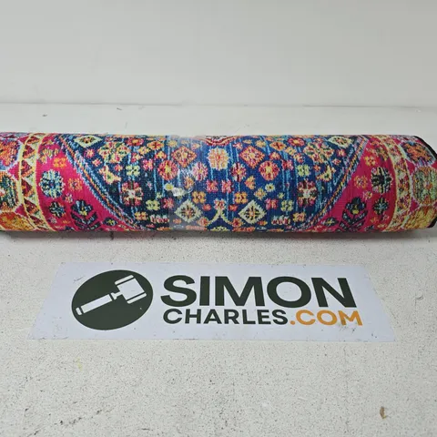 ROLLED DECORATIVE RUG WITH PINK, BLUE AND CREAM GEOMETRIC PATTERN