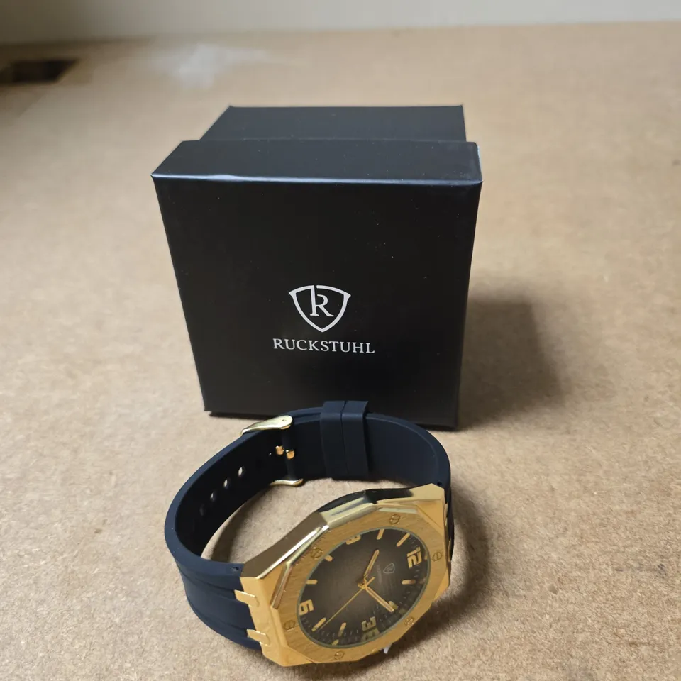 RUCKSTUHL GOLD-TONE WRISTWATCH WITH BLUE RUBBER STRAP – BOXED