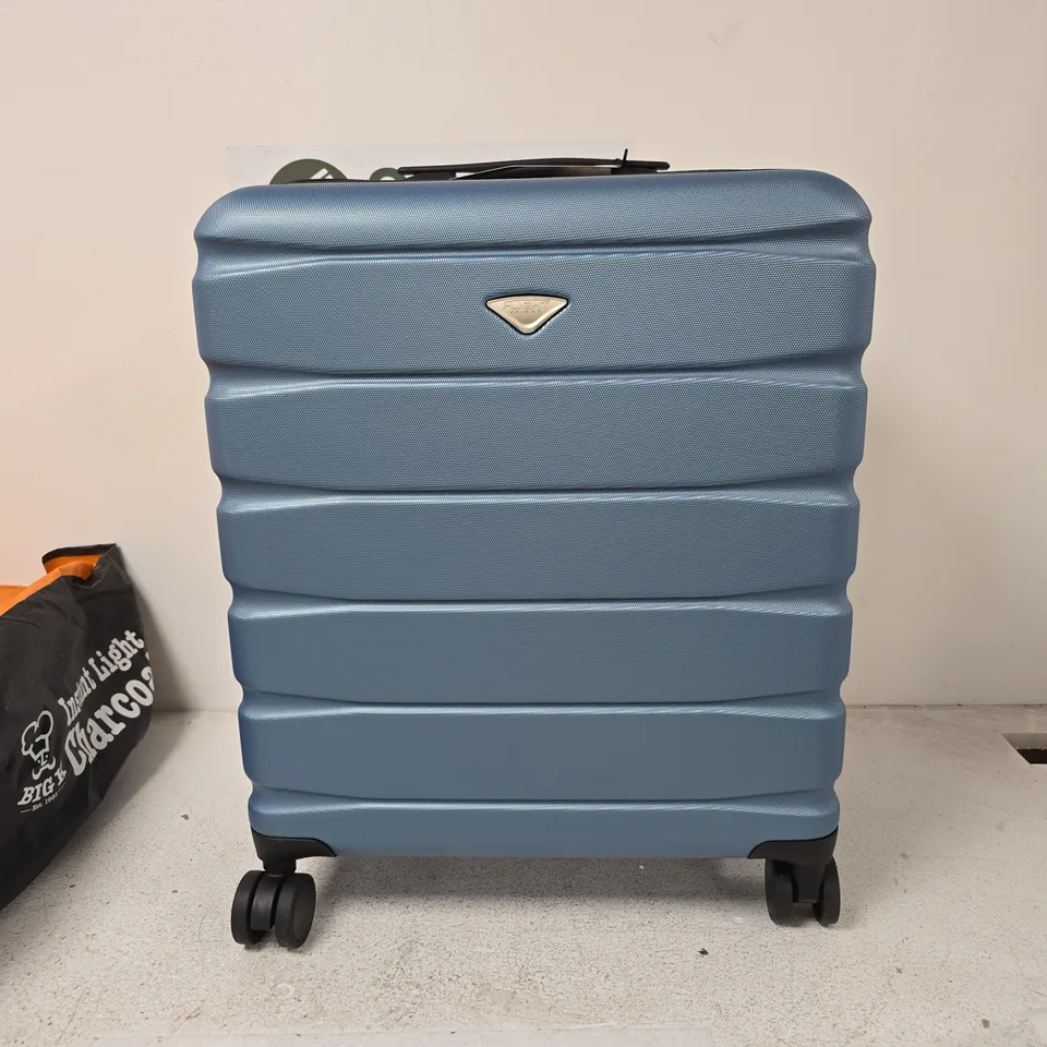 FLIGHT BLUE HARD-SHELL SUITCASE WITH FOUR WHEELS AND BUILT-IN COMBINATION LOCK