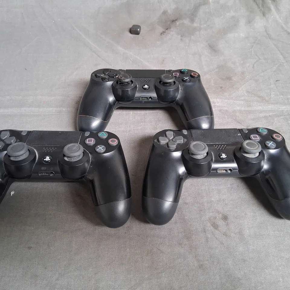 THREE ASSORTED SONY PLAYSTATION CONTROLLERS