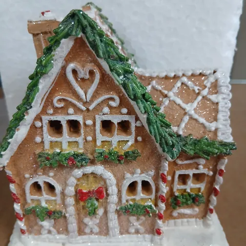 APPROXIMATELY 18 LIGHT UP FESTIVE GINGERBREAD HOUSE