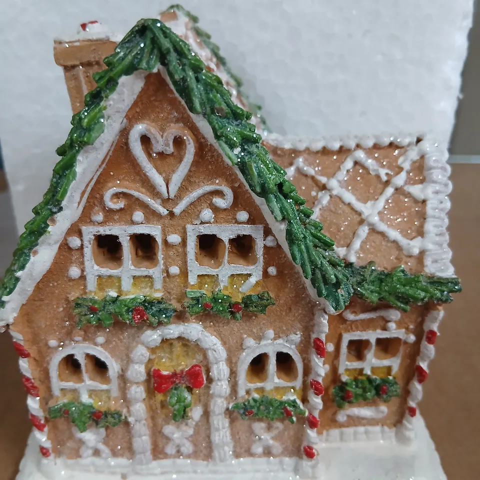 APPROXIMATELY 18 LIGHT UP FESTIVE GINGERBREAD HOUSE