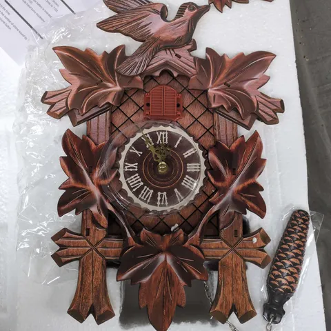 WOODEN CUCKOO CLOCK WITH CARVED LEAVES AND BIRD MOTIF