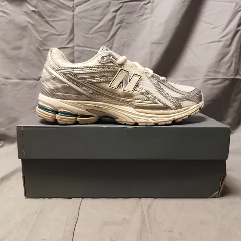 BOXED PAIR OF NEW BALANCE 1906 TRAINERS IN CREAM/SILVER SIZE UK 10