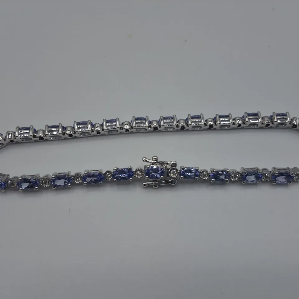 WHITE GOLD BRACELET SET WITH OVAL CUT TANZANITES AND NATURAL DIAMONDS WEIGHING +-6.11CT