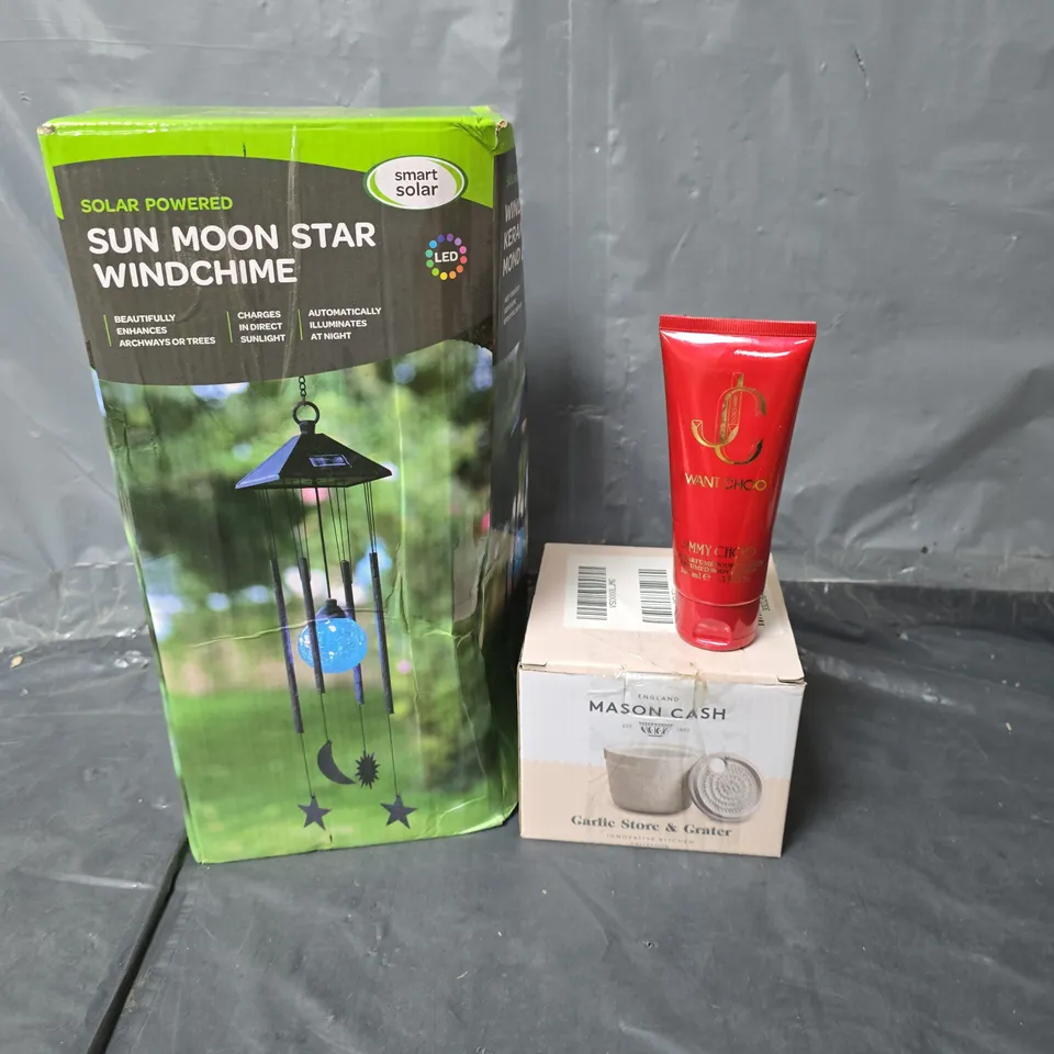 APPROXIMATELY 10 HOUSEHOLD ITEMS TO INCLUDE SUN, MOON AND STAR WINDCHIME, JIMMY CHOO BODY LOTION AND A GARLIC STORE AND GRATER