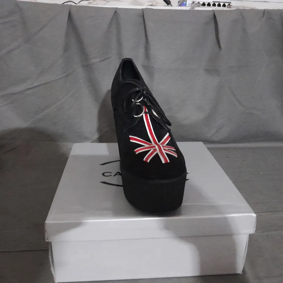 APPROXIMATELY 13 BOXED PAIR OF CASANDRA WEDGE PLATFORM SHOES IN BLACK SUEDE UK FLAG VARIOUS SIZES TO INCLUDE SIZE 6
