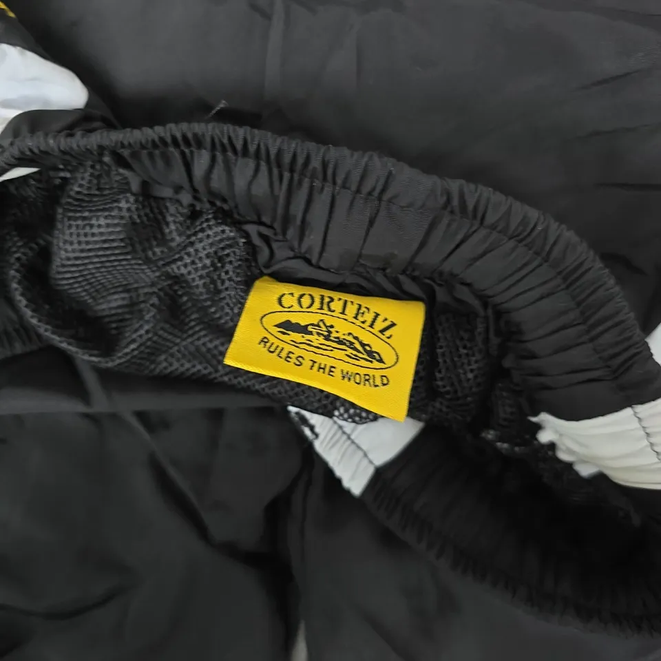CORTEIZ BLACK WINDBREAKER PANTS WITH WHITE SIDE PANELS - SIZE UNSPECIFIED