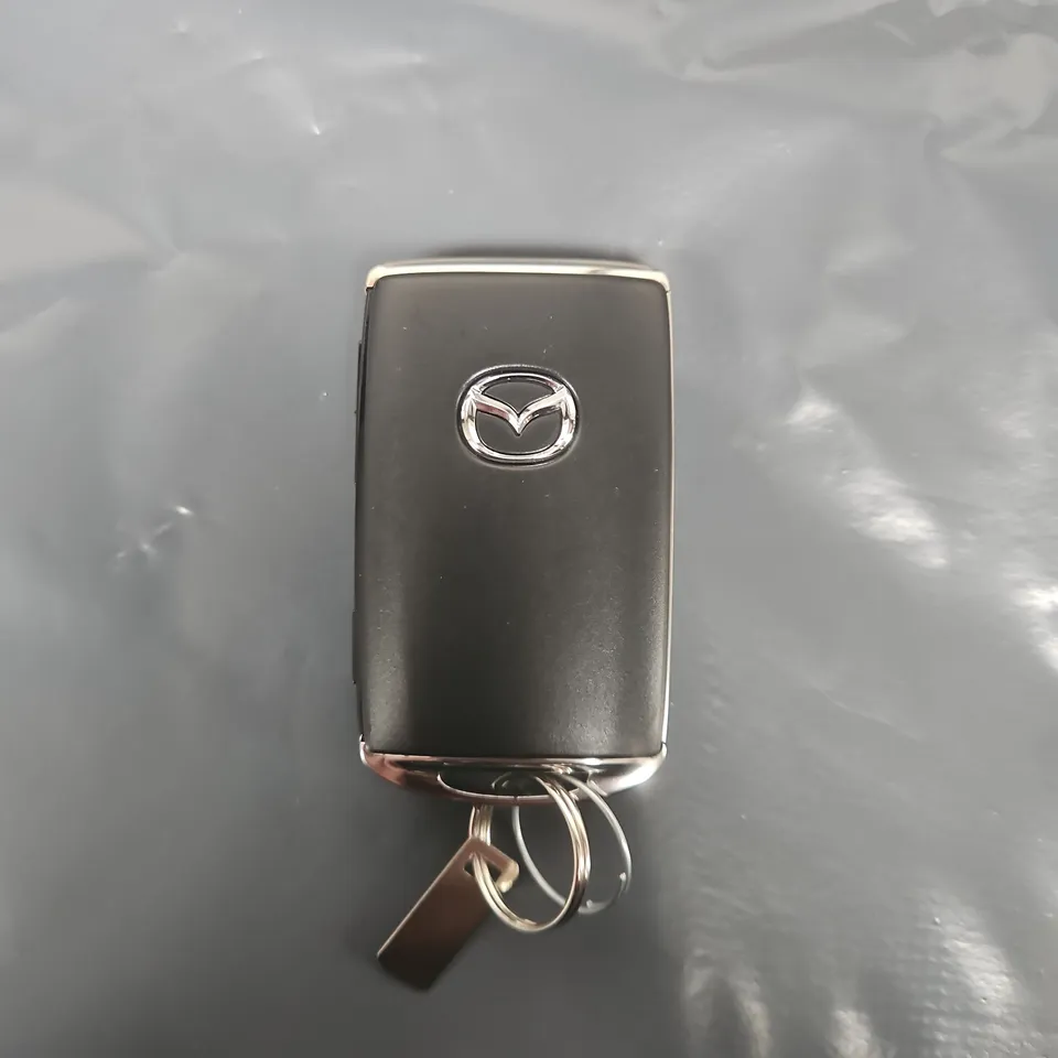 Mazda remote key fob with attached key rings