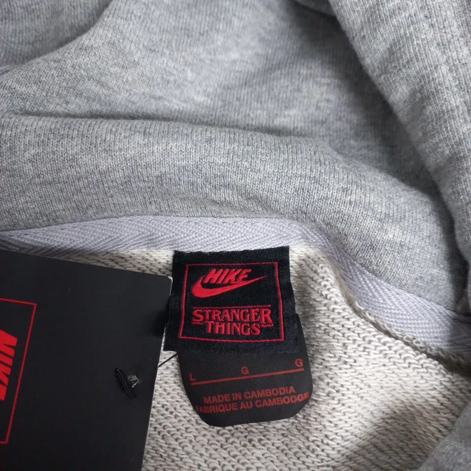 NIKE STRANGER THINGS HOODIE – GREY, UK L (LG) SIZE
