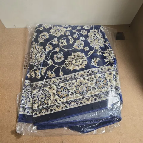 PATTERN OVER BLUE RUG - SIZE UNSPECIFIED