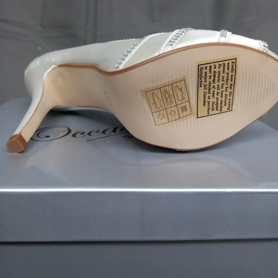 BOX OF 14 PAIRS OF IVORY SATIN HIGH HEELED SHOES 