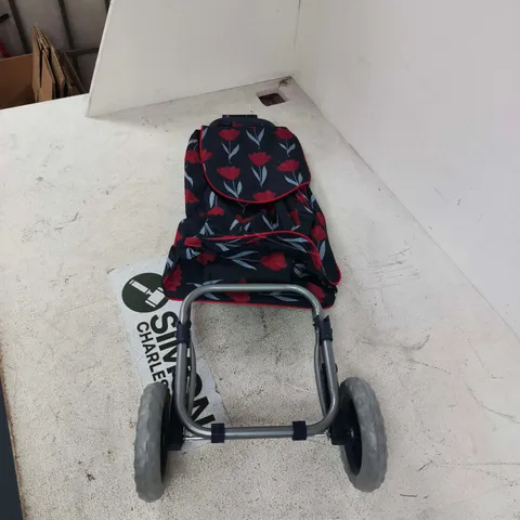 SHOPPING TROLLEY FEATURING A BLACK AND FLORAL PATTERN BAG