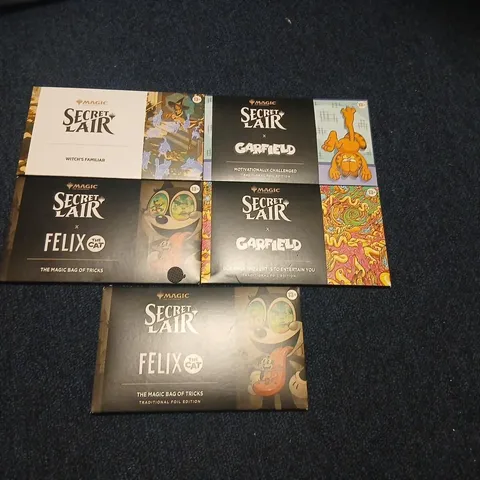 SIX ASSORTED MAGIC: THE GATHERING SECRET LAIR BOOSTERS TO INCLUDE; GARFIELD & FELIX THE CAT EACH PACK CONTAINS 5 CARDS
