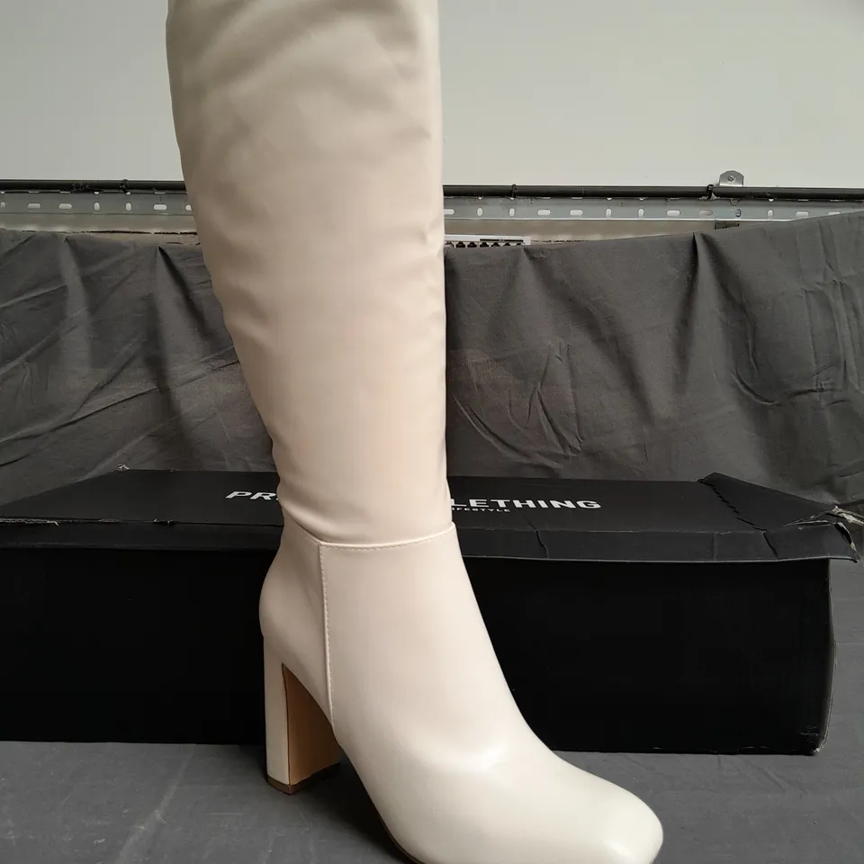 BOXED PAIR OF PRETTYLITTLETHING CREAM HEELED BOOTS SIZE UK 9