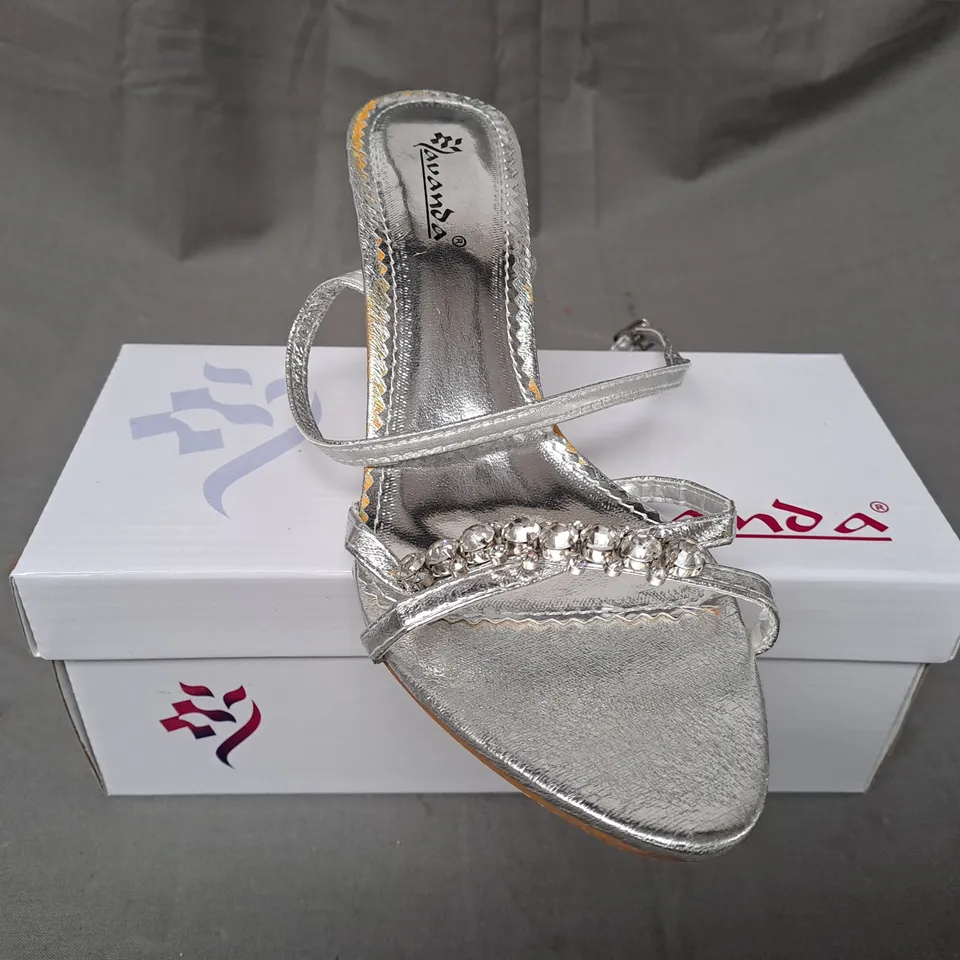 BOX OF APPROXIMATELY 20 PAIRS OF LAVANDA OPEN TOE STRAPPY HEELED SANDALS IN METALLIC SILVER IN VARIOUS SIZES