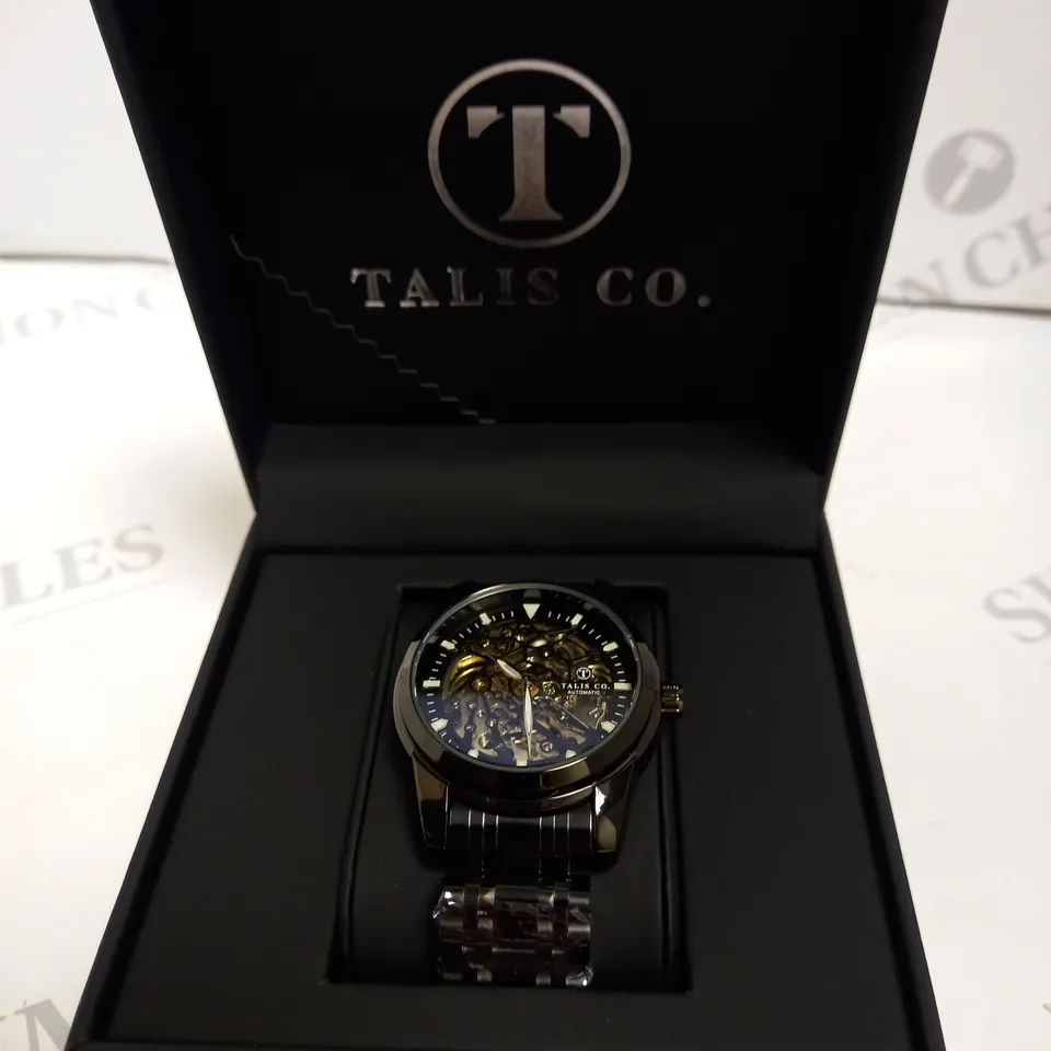 MEN’S TALIS CO 7820 AUTOMATIC WATCH – BLACK SKELETON DIAL AND CASE – STAINLESS STEEL STRAP – GLASS BACKCASE.