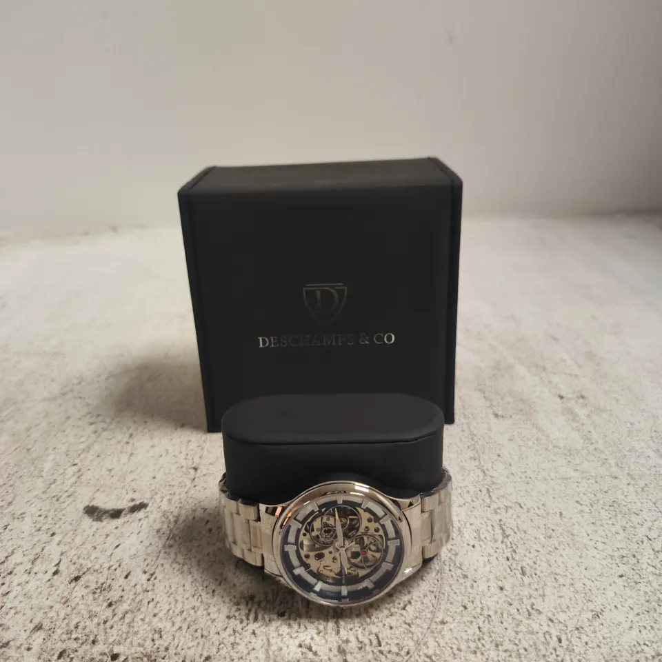 WRISTWATCH WITH SKELETON DIAL IN DESCHAMPS & CO PRESENTATION BOX, STAINLESS STEEL BRACELET