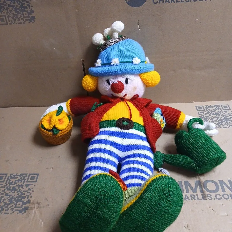 KNITTED CLOWN PLUSH TOY WITH BLUE HAT, STRIPED LEGS AND GREEN SHOES