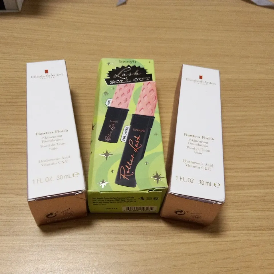THREE ASSORTED COSMETICS TO INCLUDE; ELIZABETH ARDEN FLAWLESS FINISH SKINCARING FOUNDATION AND BENEFIT LASH ROLL OUT