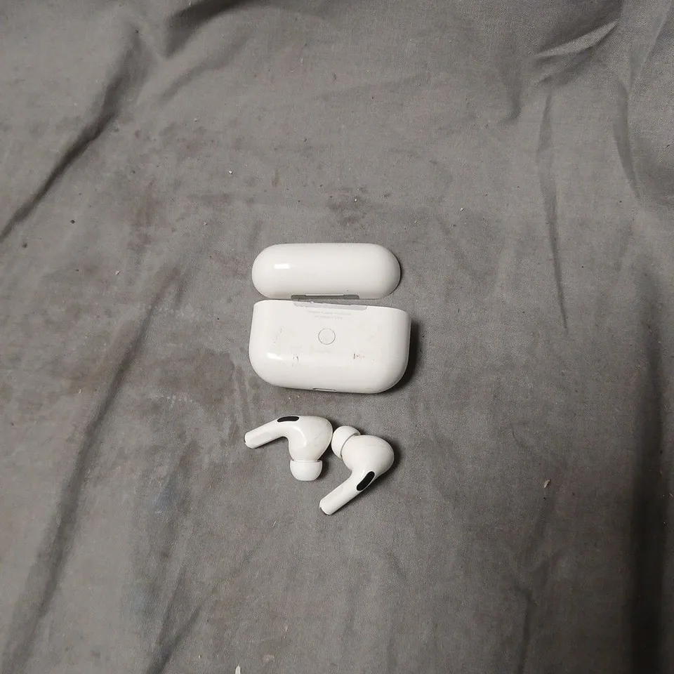 WHITE WIRELESS EARBUDS WITH CHARGING CASE. MODEL UNSPECIFIED.