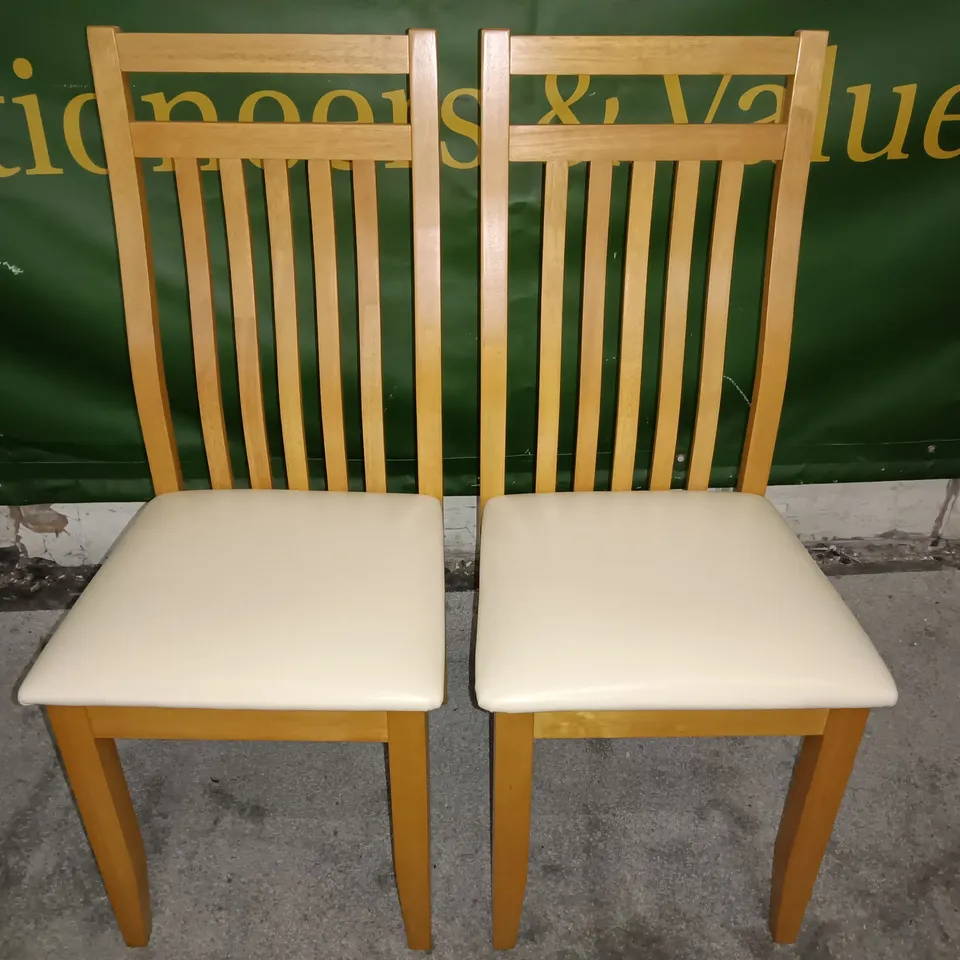 PAIR OF WOODEN SLAT BACK DINING CHAIRS WITH CREAM FAUX LEATHER SEAT PADS 