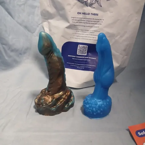 TWO SILICONE SEX TOYS (DILDOS) – BLUE AND BRONZE-TONED WITH TEXTURED BASE