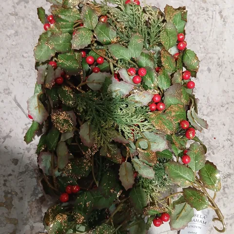 TWO GISELA GRAHAM ARTIFICIAL CHRISTMAS GARLAND WITH HOLLY LEAVES, RED BERRIES AND GLITTER