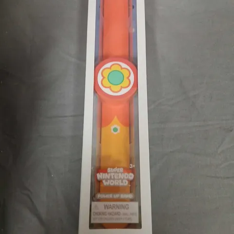 POWER UP BAND – SUPER NINTENDO WORLD, ORANGE WITH FLOWER EMBLEM, IN ORIGINAL PACKAGING