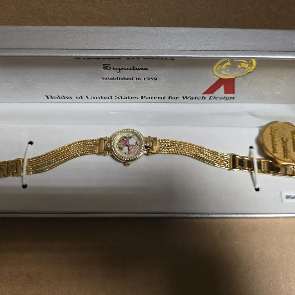 MARCEL DRUCKER GOLD TONE WRISTWATCH WITH FLORAL FACE