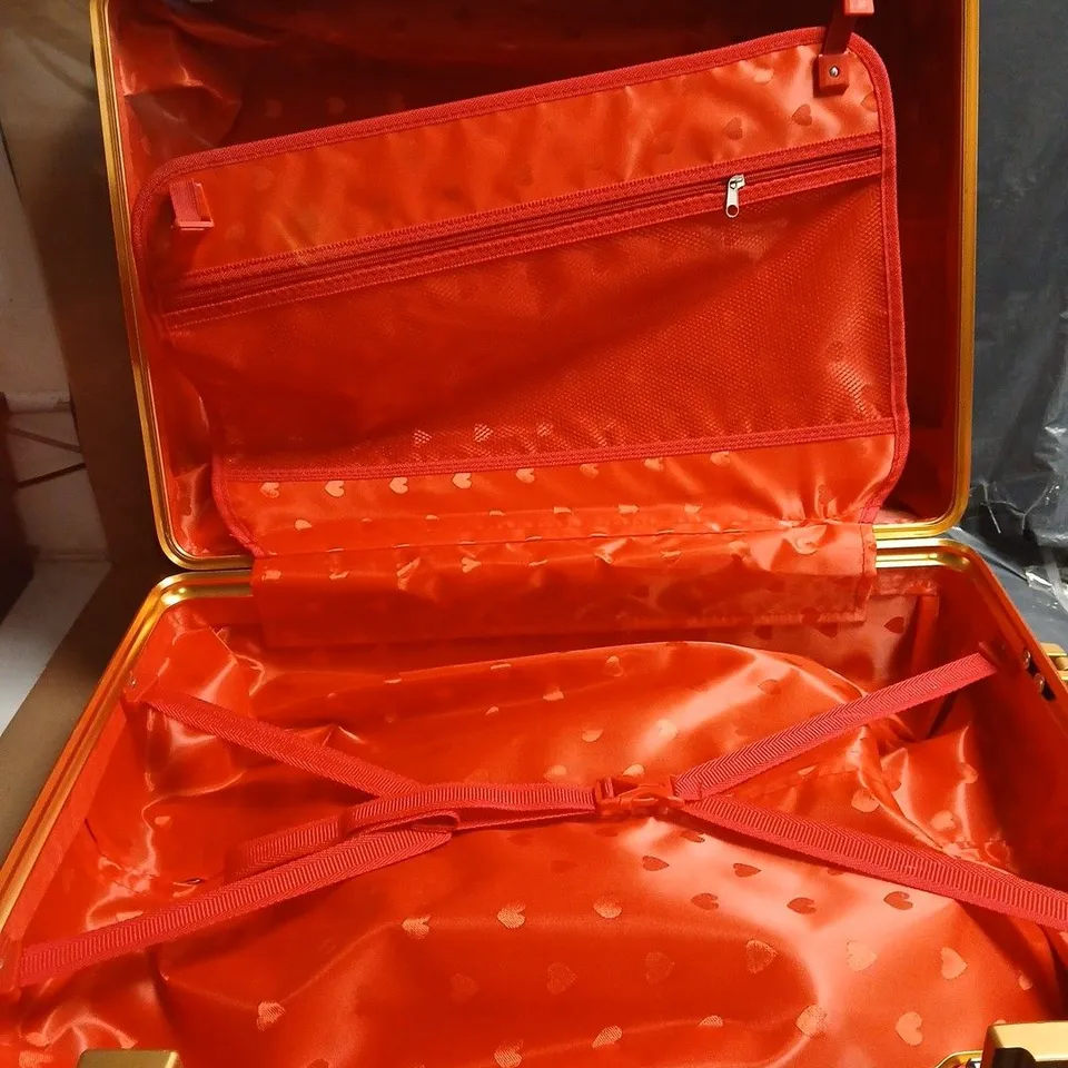 RED HARD-SHELL SUITCASE WITH GOLD-TONE CORNERS; LINING WITH HEART PATTERN. WITH SIDE CARRY HANDLE OPTION