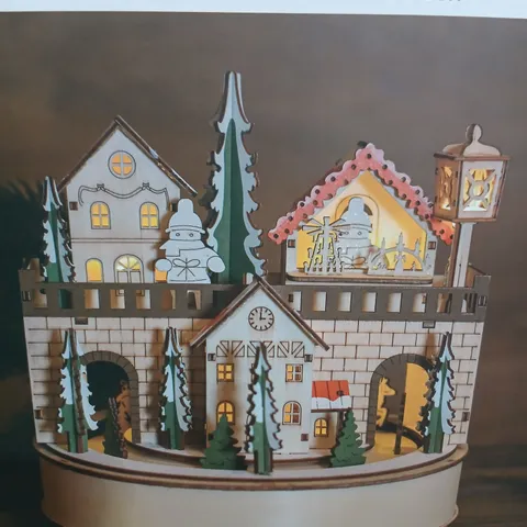 FOUR BOXED WOODEN CHRISTMAS HOUSE MUSIC BOX