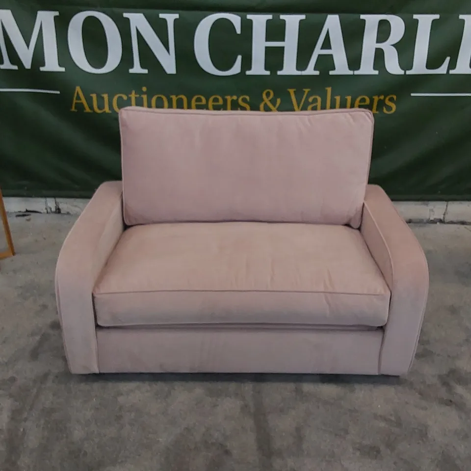 THE DUNSMORE LOVE SEAT SOFA BED UPHOLSTERED IN PETAL PINK FABRIC 