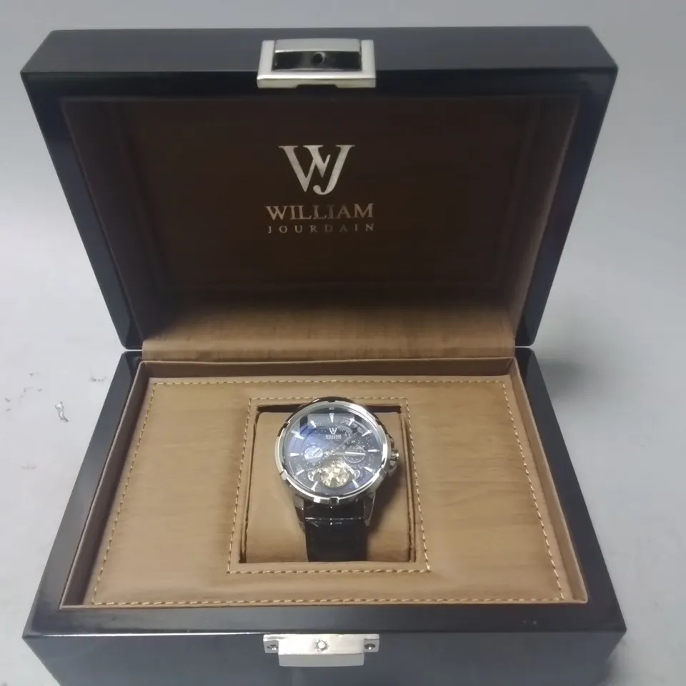 WILLIAM JOURDAIN STAINLESS STEEL GENTS CHRONOGRAPH WATCH WITH SKELETON BACK AND BLACK LEATHER STRAP IN WOODEN GIFT BOX