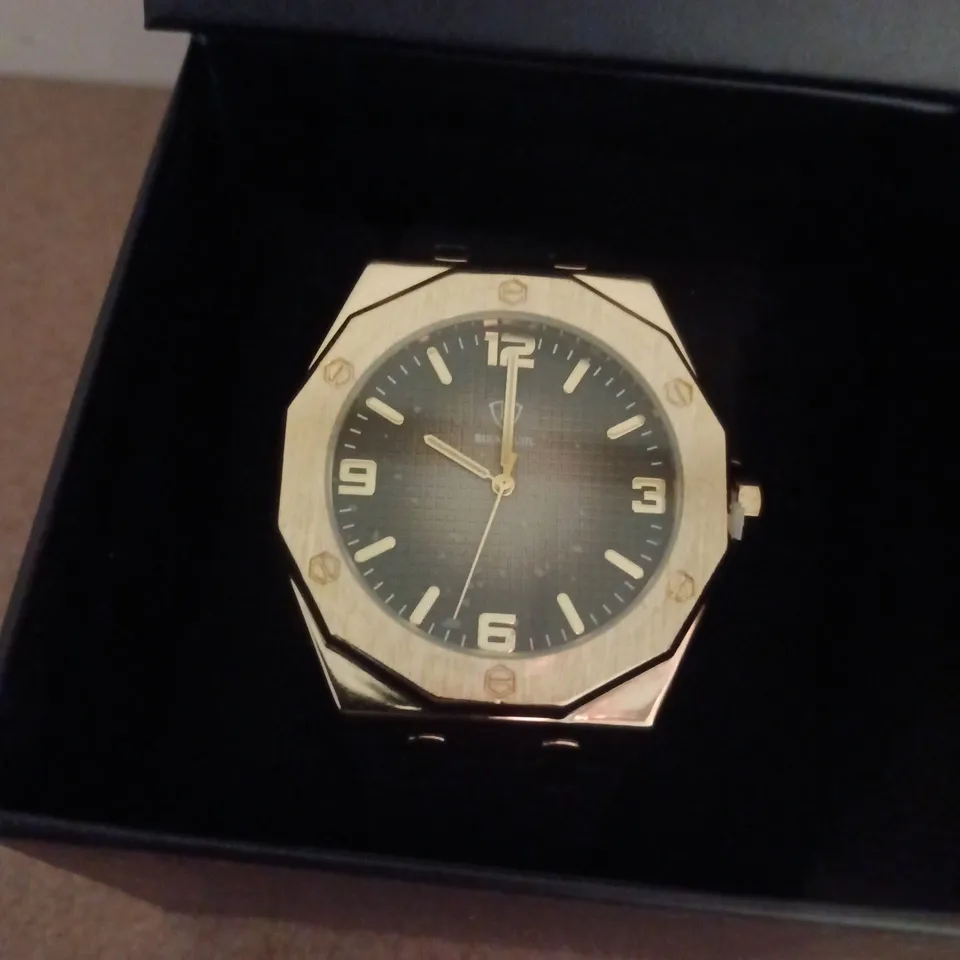 RUCKSTUHL GOLD COLOUR WRISTWATCH WITH BLACK RUBBER STRAP