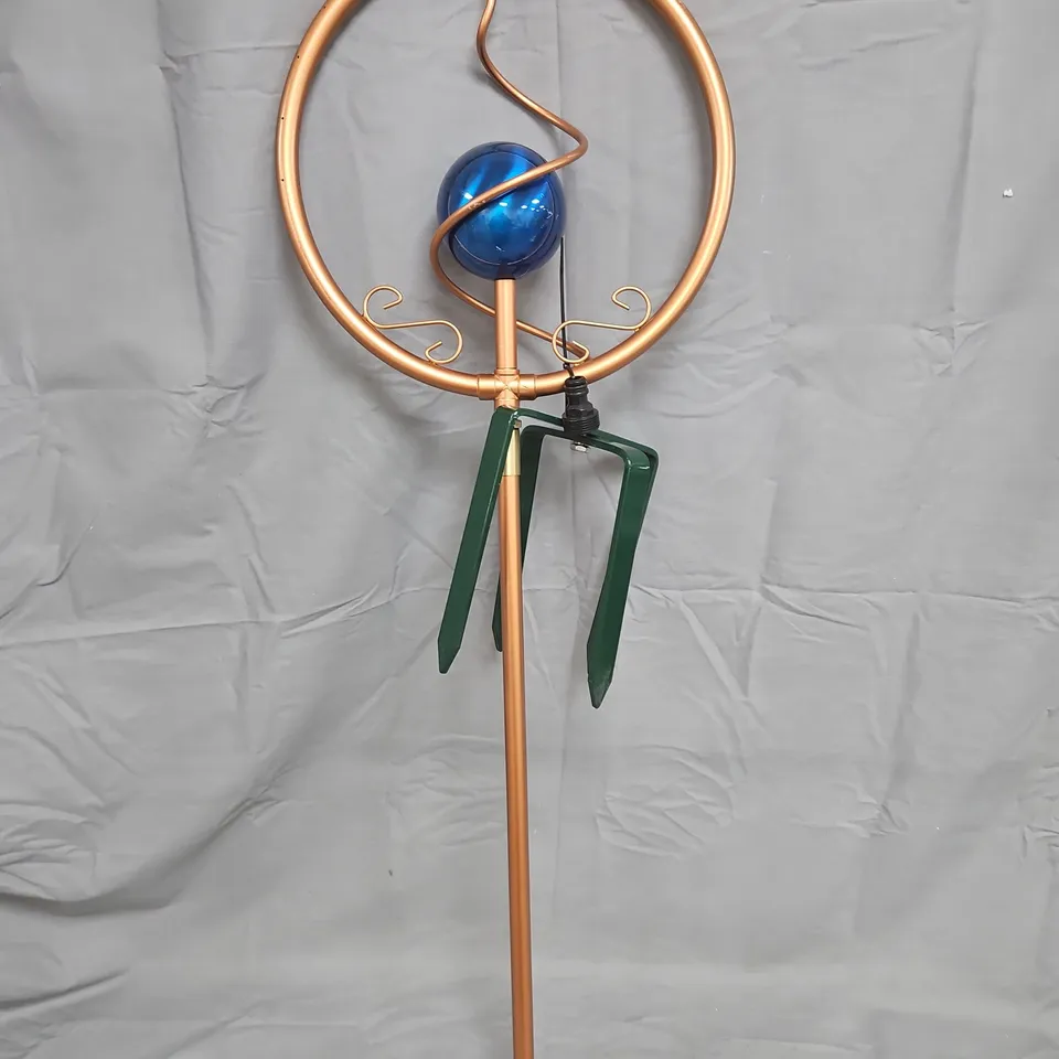 COPPER GARDEN SCULPTURE WITH CIRCULAR RING, BLUE GLASS ORB AND LEAF ACCENTS