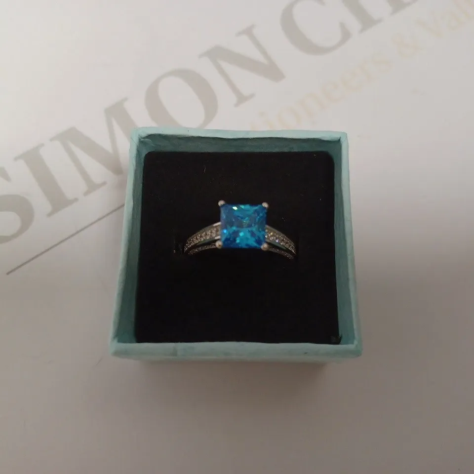 SILVER LOOP RING WITH PRINCESS CUT BLUE STONE
