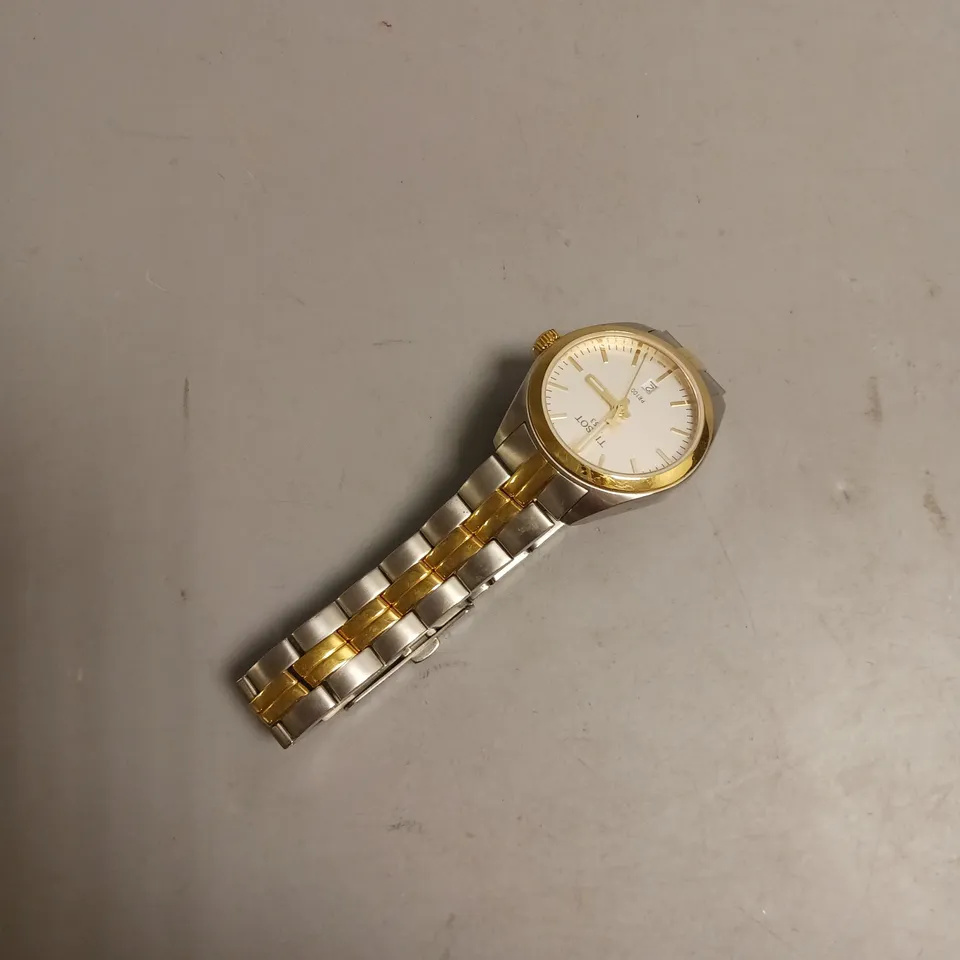 TISSOT WATCH IN GOLD AND SILVER INCLUDES BOOK THE STORY OF A WATCH COMPANY BY ESTELLER FALLET