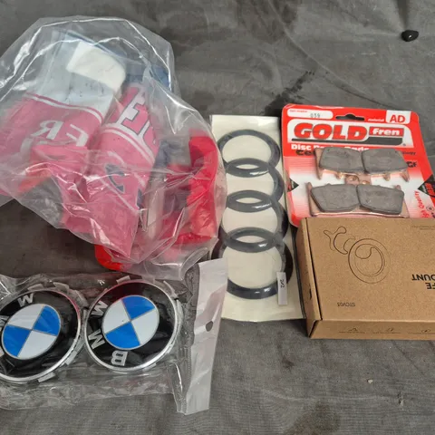 TOTE OF ASSORTED CAR ITEMS TO INCLUDE CAR BADGES , BRAKE PADS AND ACRYLIC PAINT 