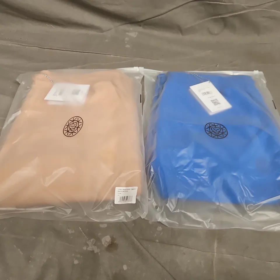 APPROXIMATELY 20 ASSORTED BAGGED UNISEX BRASS MONKEY JOGGERS IN VARIOUS SIZES IN COLOURS SUCH AS CORAL & BLUE