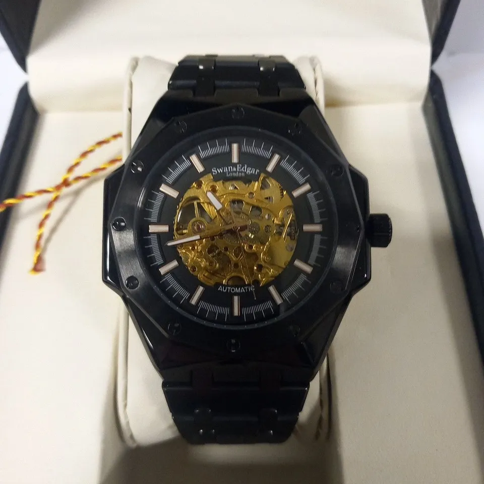 BOXED SWAN & EDGAR AUTOMATIC BLACK WRIST WATCH WITH SKELETON FACE
