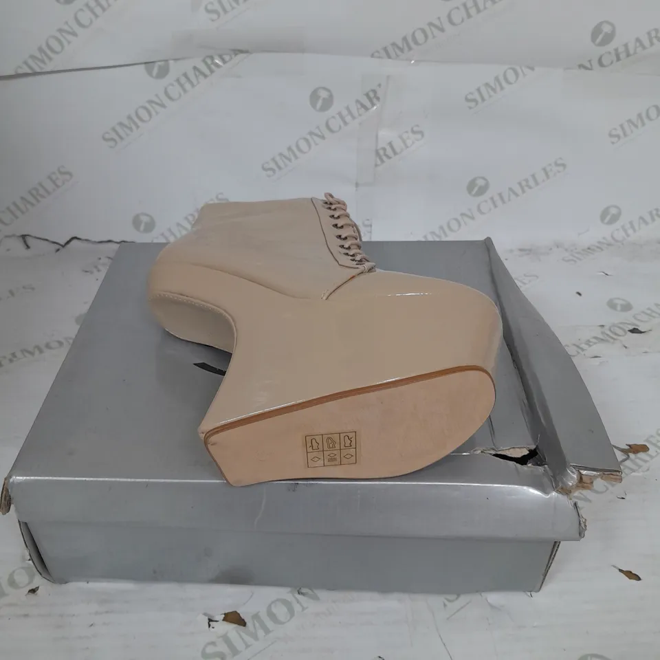 BOXED PAIR OF CASANDRA PLATFORM LACE UP ANKLE BOOT IN NUDE PATENT SIZE 5