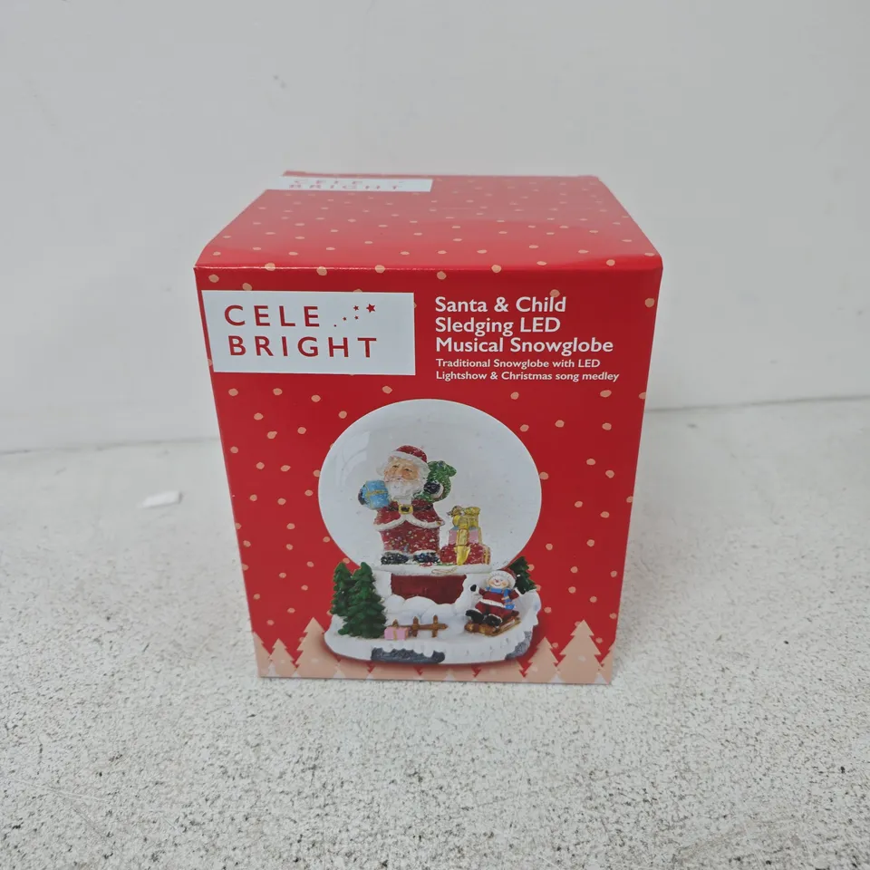 BOXED CELEBRIGHT SANTA & CHILD SLEDGING LED MUSICAL SNOWGLOBE