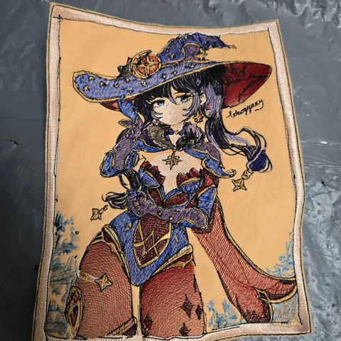 EMBROIDERED FANTASY CHARACTER PATCH ON BEIGE FABRIC